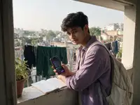 A student self-studying for NEET on a rooftop in the morning light